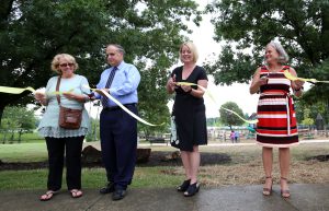 CM Peggy Henson, Commissioner Geoffrey Reed, Director Monica Conrad and CM Jennifer Scutchfield cut the ribbon for the new playground at Jacobson Park Aug. 2, 2016.