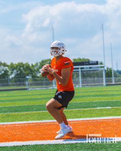 Lexington: a high school football player in an orange uniform