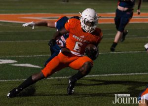 Lexington: high school student playing football in a orange uniform