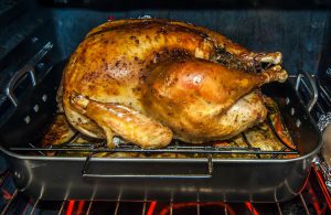 thanksgiving turkey on a pan in the oven