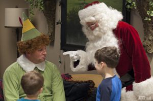 Santa and Buddy talking to a few kids
