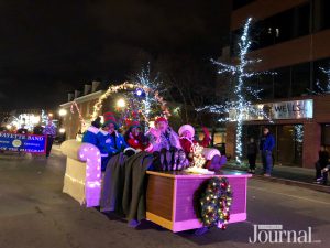 a group of characters sitting on a couch "watching tv" in the christmas parade