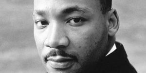 black and white image of martin luther king, jr. looking at the camera