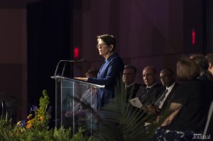 COVID-19 inaugural ceremony: linda gorton at a podium giving a speech