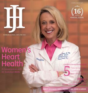 cover: woman in a pink top with a white labcoat smiling at the camera