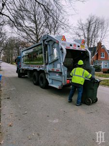 waste: a garbage truck and a waste collector