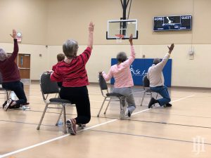 SilverSneakers: older people doing chair yoga