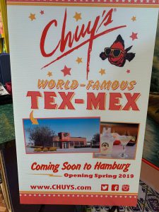 a sign that say's chuy's world-famous tex-mex with pictures of new location