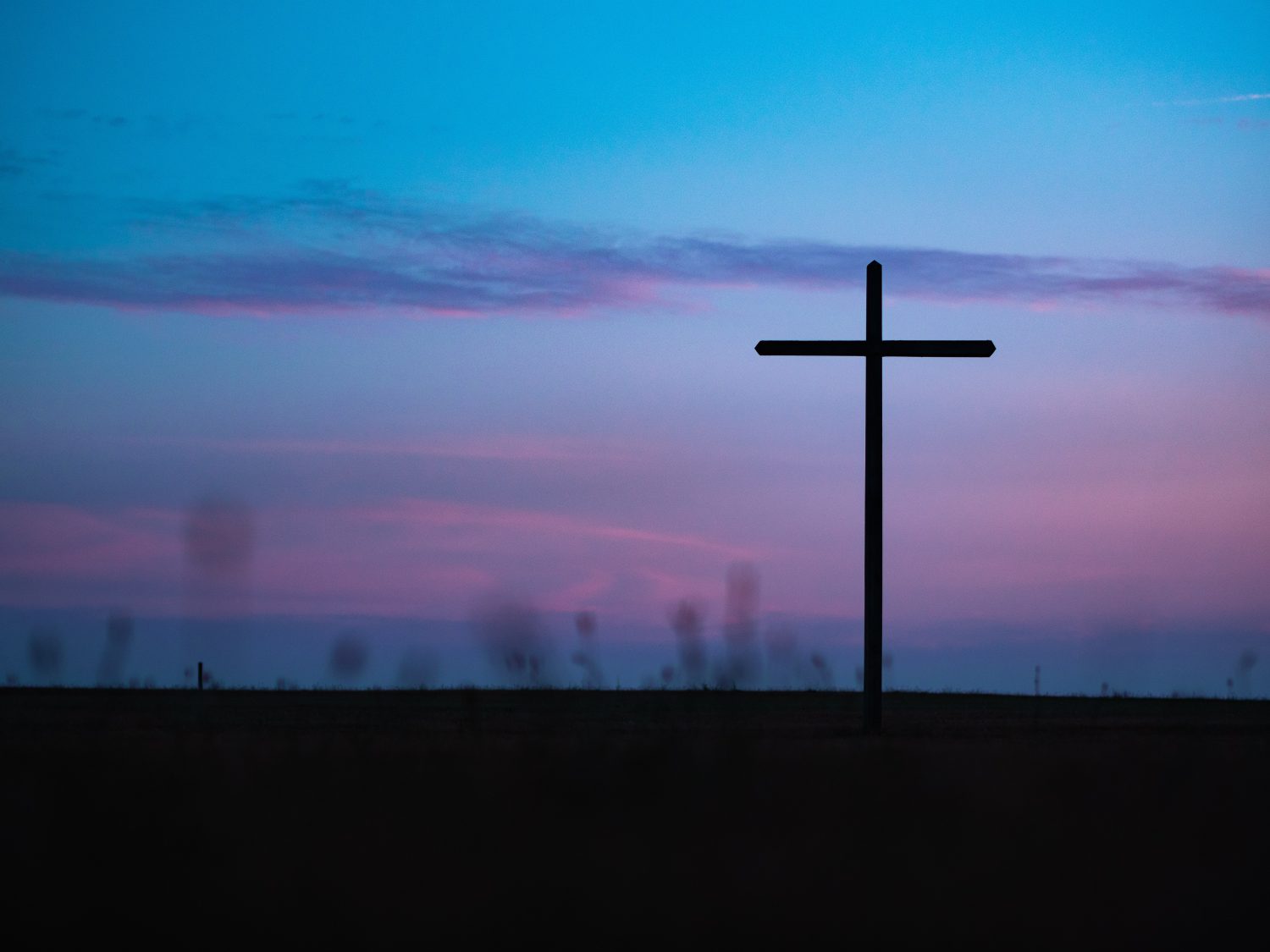 ash wednesday: blue and purple sky with a cross silhouette