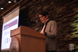 Women Leading Kentucky: woman in a blazer at a podium giving a speech
