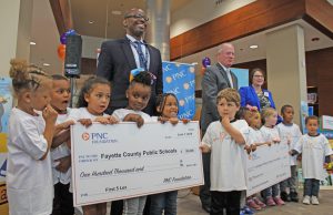 Parents Fayette County Public Schools: group of adults and kids holding up big checks