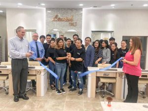 Business: group of people cutting a blue ribbon