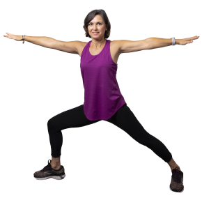 Yoga: a woman doing warrior two in a purple top and black pants