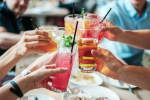 bars: group of people cheersing with alcoholic drinks